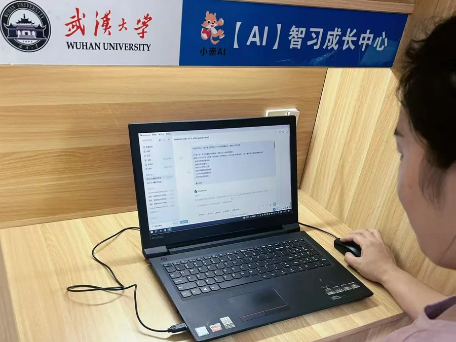 武汉大学AI智习成长中心自习位,学生正在笔记本电脑上使用AI学习工具